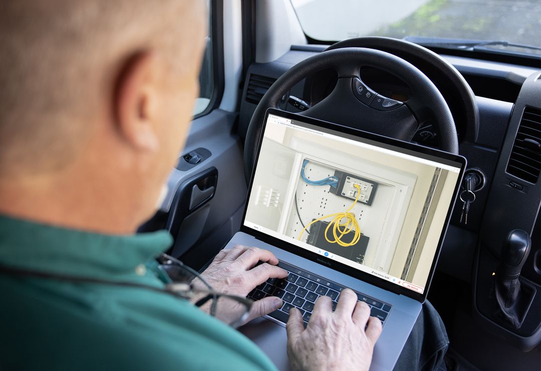 A man uses Streem remote video on his laptop in his van